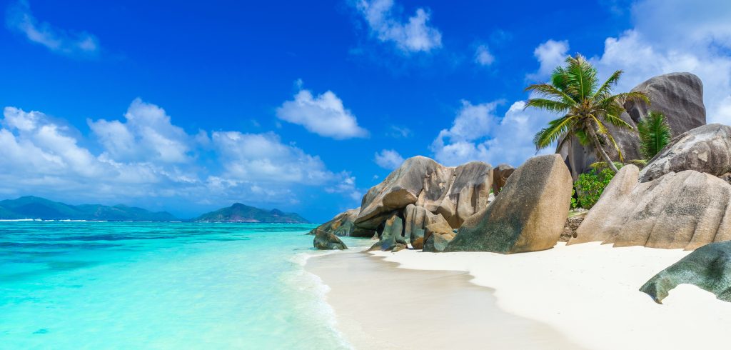 A landscape image of a beach in the Seychelles.